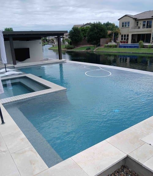 Quality King technician servicing a backyard pool